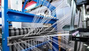 Weaving machines working with white threads to make the best Woolen Blanket.